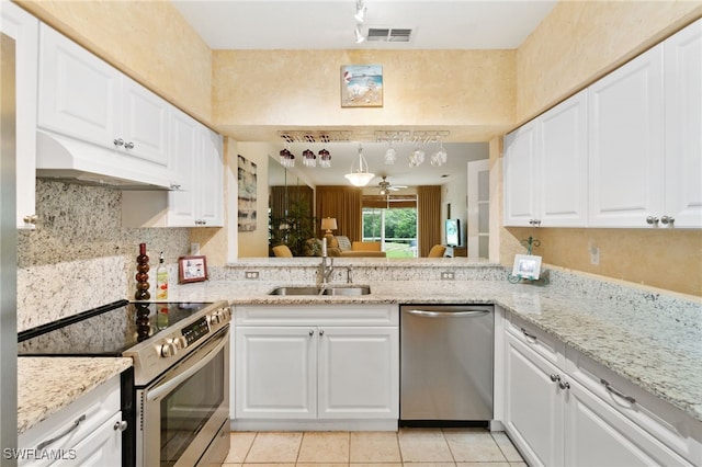 kitchen with white cabinets, light tile patterned floors, sink, and appliances with stainless steel finishes