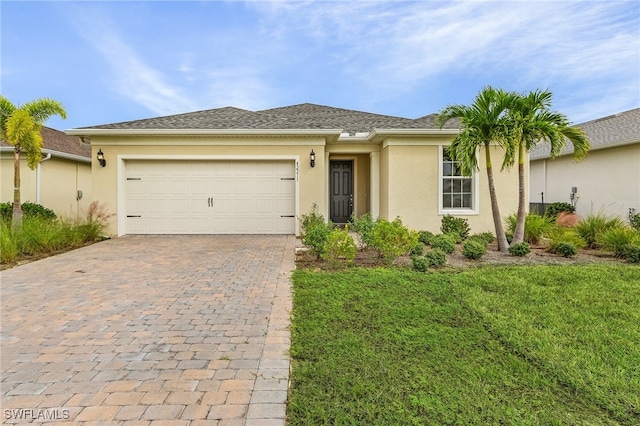 view of front of house featuring a garage and a front lawn