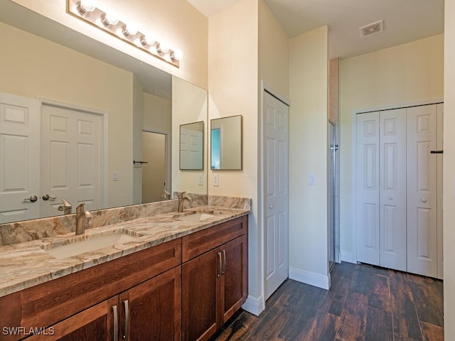 bathroom featuring vanity and wood-type flooring