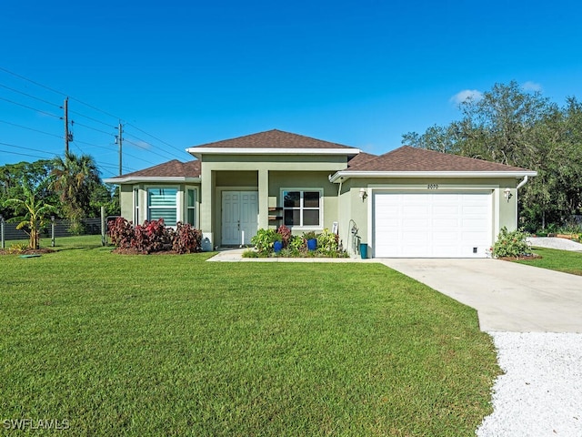 ranch-style home featuring a garage and a front yard