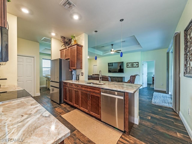 kitchen with stainless steel appliances, dark wood-type flooring, sink, and pendant lighting