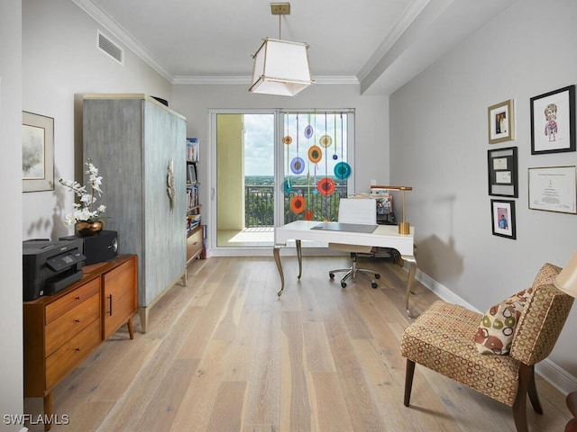 home office with light wood-type flooring and crown molding