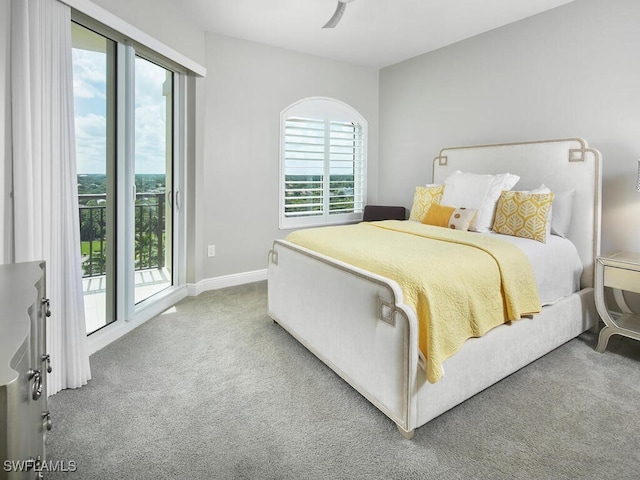 bedroom with ceiling fan, access to exterior, multiple windows, and carpet