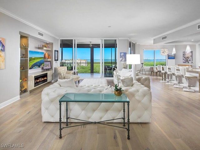 living room featuring hardwood / wood-style flooring and crown molding