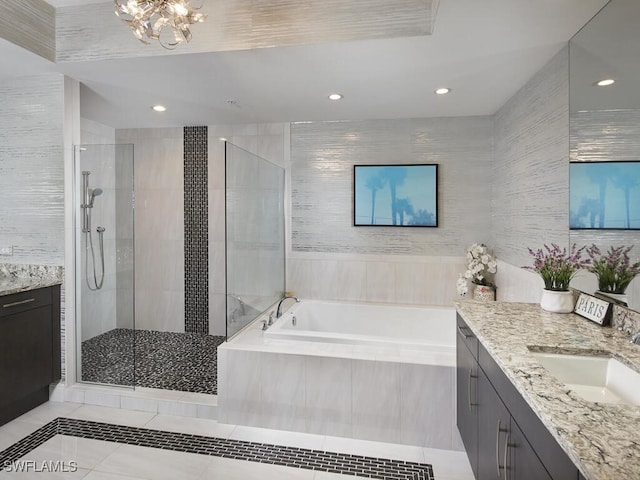 bathroom featuring vanity, plus walk in shower, and tile patterned flooring