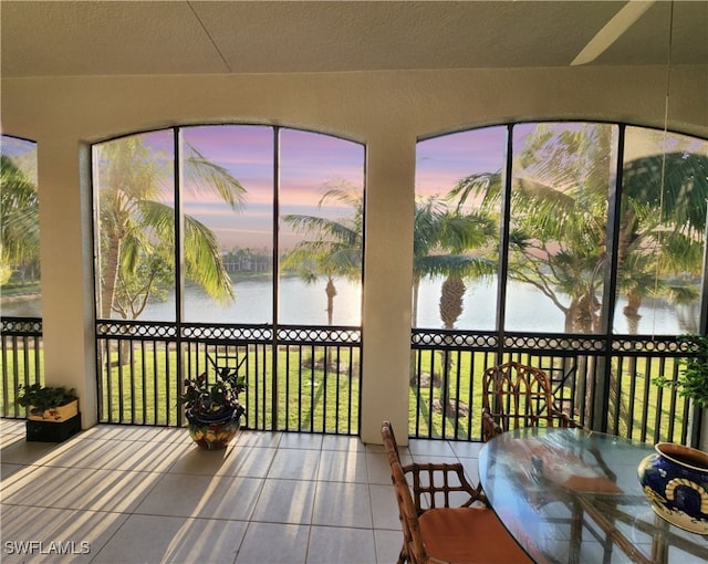 sunroom / solarium with a water view