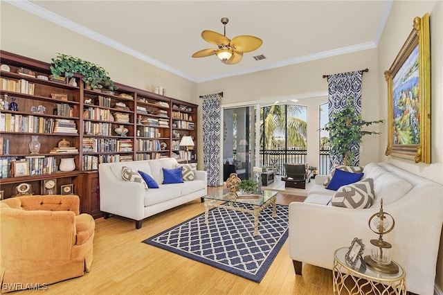 sitting room featuring ornamental molding, hardwood / wood-style floors, and ceiling fan