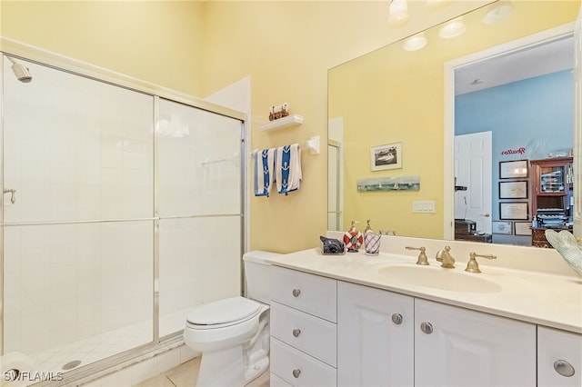 bathroom with walk in shower, vanity, toilet, and tile patterned floors