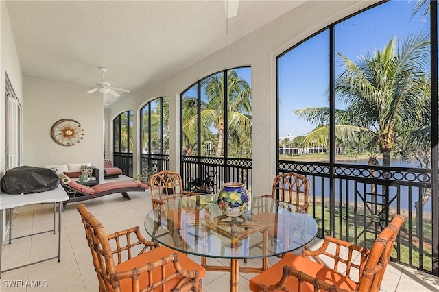 sunroom with a wealth of natural light and ceiling fan