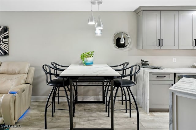 dining room with light hardwood / wood-style flooring and beverage cooler