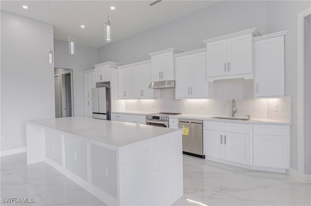 kitchen featuring stainless steel appliances, a kitchen island, pendant lighting, sink, and white cabinets