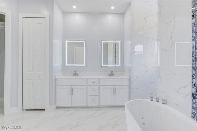 bathroom with a tub and vanity