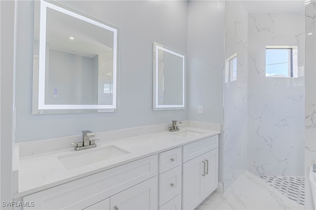 bathroom with tiled shower and vanity