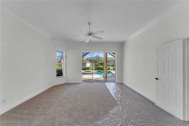 11752 Longshore Way W, Naples, FL 34119 - spare room featuring crown molding, ceiling fan, a sunroom, baseboards, and carpet flooring