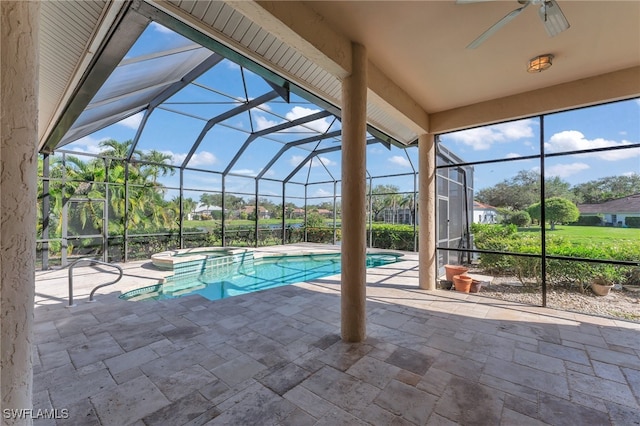 view of pool with a lanai, a patio area, an in ground hot tub, and ceiling fan