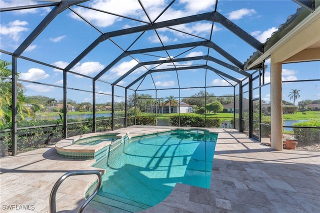 view of swimming pool featuring an in ground hot tub, a water view, glass enclosure, and a patio area