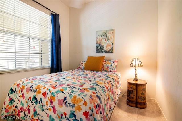 bedroom with light tile patterned floors