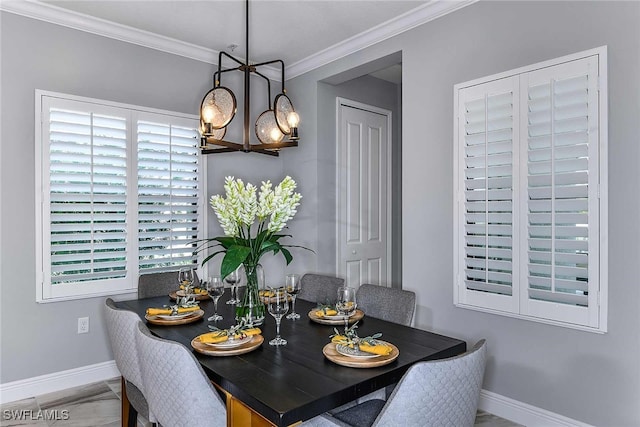 dining room featuring ornamental molding and an inviting chandelier