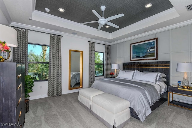 bedroom with carpet, ceiling fan, and a raised ceiling