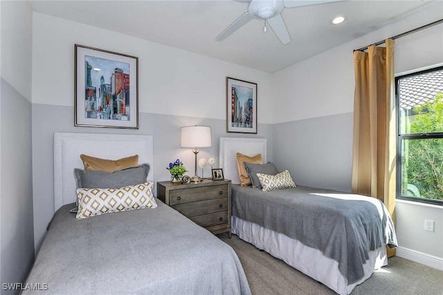 bedroom featuring ceiling fan, multiple windows, and carpet