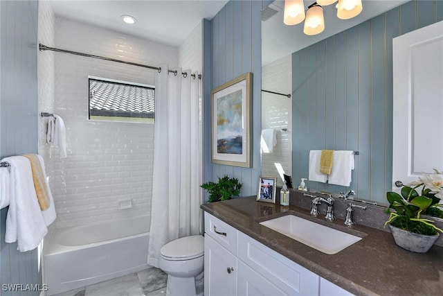 full bathroom featuring shower / bath combo with shower curtain, vanity, and toilet