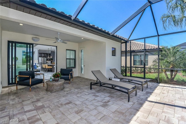 view of patio / terrace with a lanai, outdoor lounge area, and ceiling fan