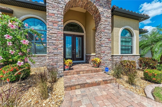 view of exterior entry featuring french doors