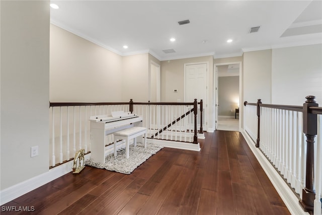 hallway with crown molding and dark hardwood / wood-style flooring