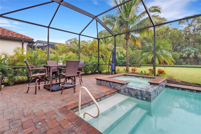 view of pool featuring a lanai, an in ground hot tub, and a patio area