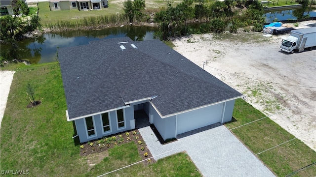 birds eye view of property with a water view