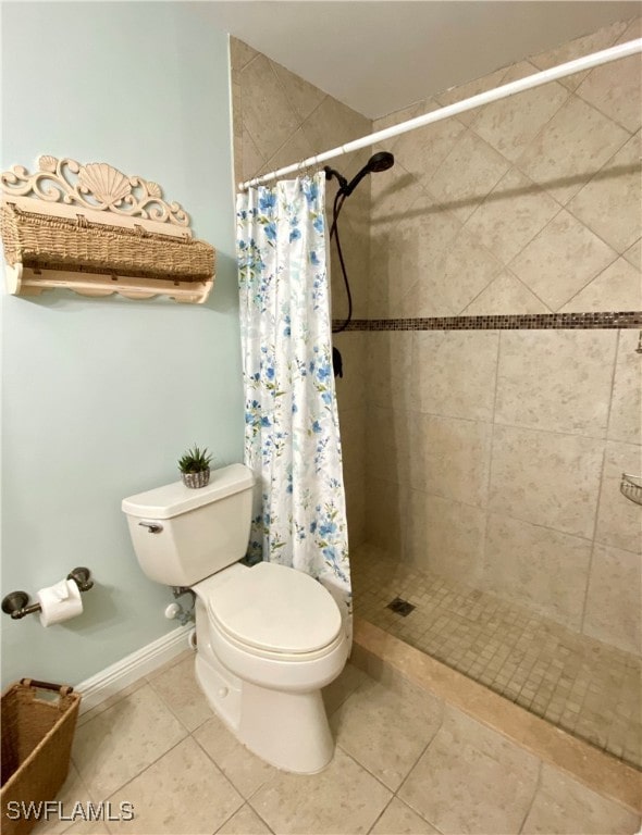 bathroom featuring toilet, tile patterned flooring, and curtained shower