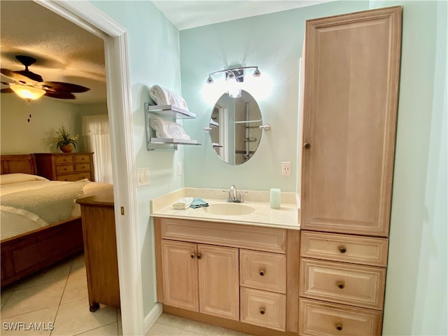 bathroom featuring vanity, a textured ceiling, tile patterned floors, and ceiling fan