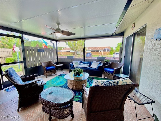 sunroom featuring ceiling fan