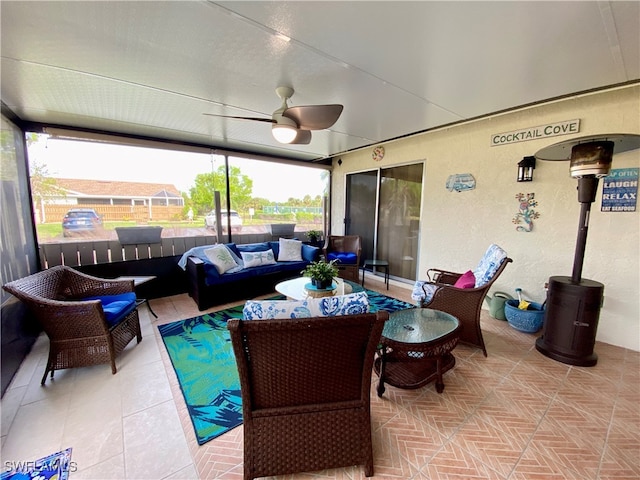 sunroom featuring ceiling fan