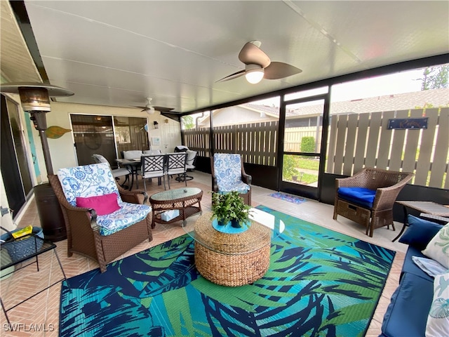 sunroom featuring ceiling fan