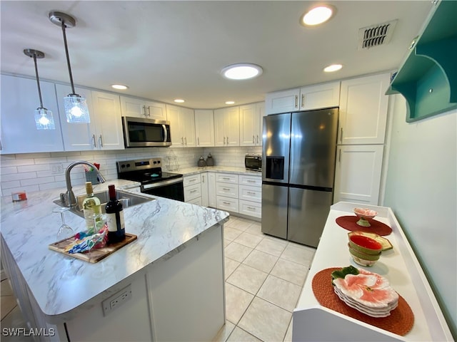 kitchen with tasteful backsplash, light tile patterned flooring, stainless steel appliances, sink, and white cabinets