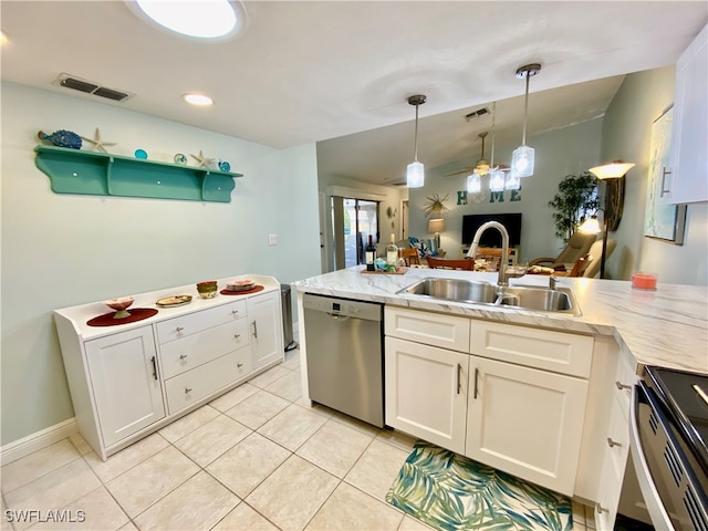 kitchen featuring stainless steel appliances, pendant lighting, vaulted ceiling, sink, and white cabinetry