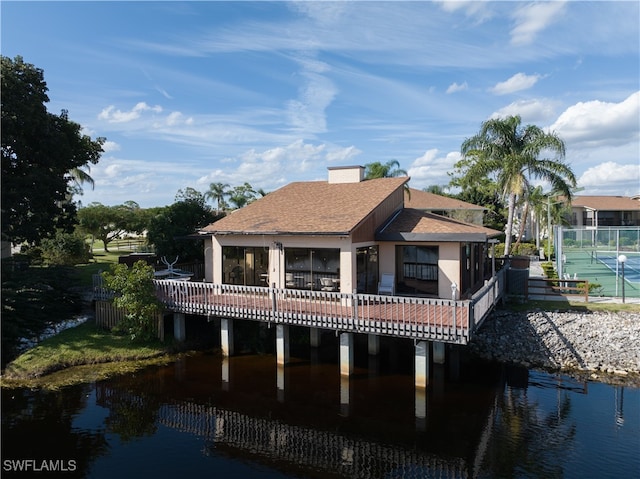 rear view of property with a water view