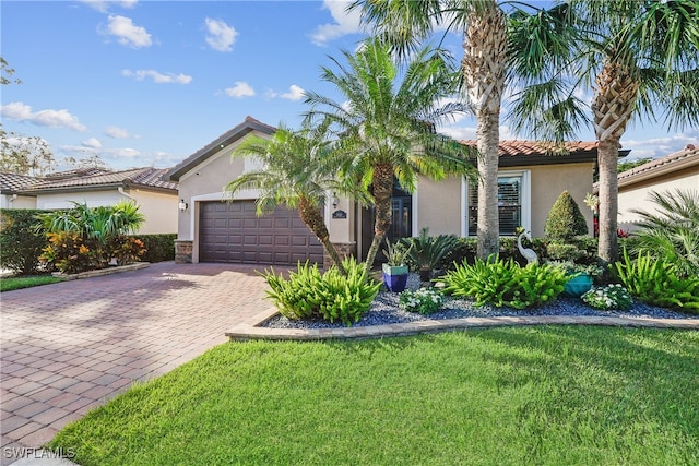 mediterranean / spanish-style home with a front lawn and a garage