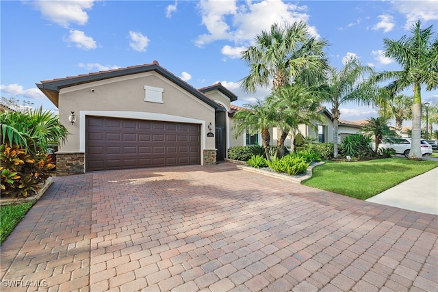 view of front of house with a garage and a front lawn