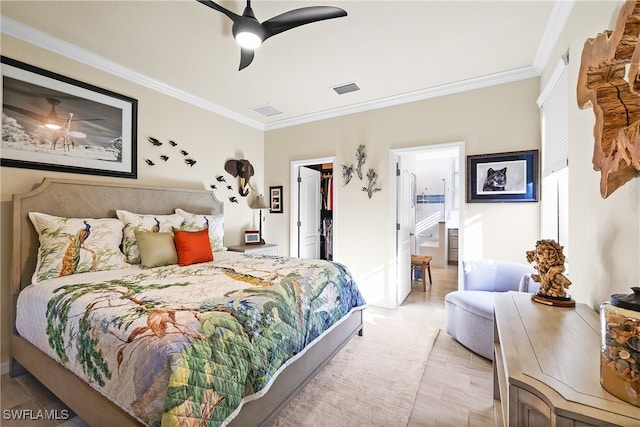 bedroom with ensuite bath, ceiling fan, a spacious closet, ornamental molding, and a closet