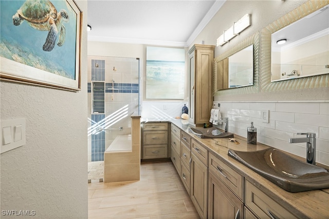 bathroom with decorative backsplash, hardwood / wood-style floors, vanity, and ornamental molding