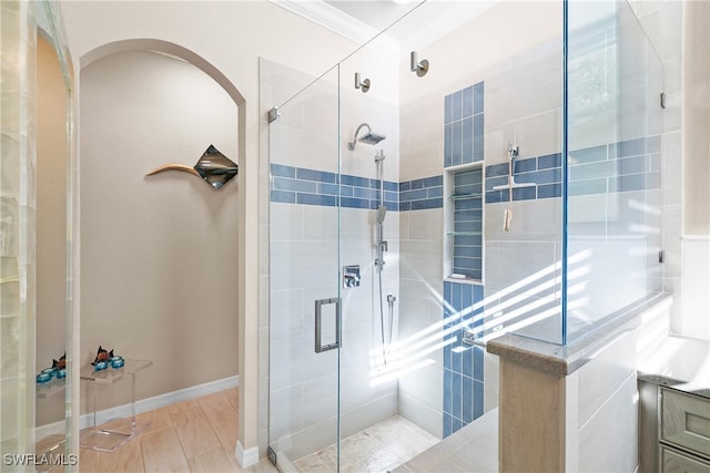 bathroom with walk in shower and ornamental molding