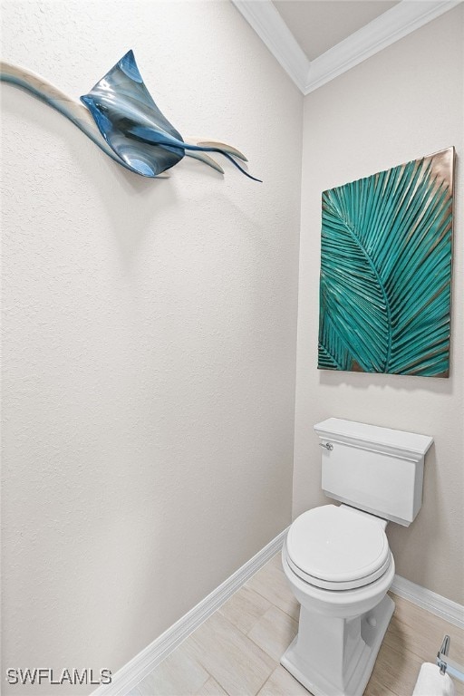 bathroom featuring toilet and ornamental molding