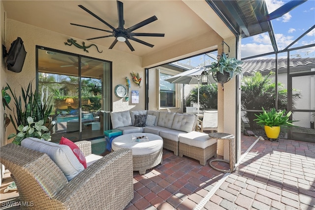 sunroom / solarium featuring ceiling fan