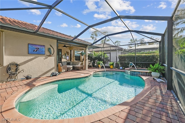 view of swimming pool with an outdoor living space, a lanai, an in ground hot tub, and a patio