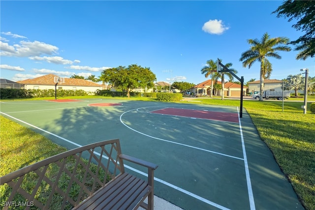 view of sport court with a lawn