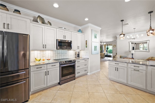 kitchen with hanging light fixtures, ornamental molding, appliances with stainless steel finishes, tasteful backsplash, and white cabinetry