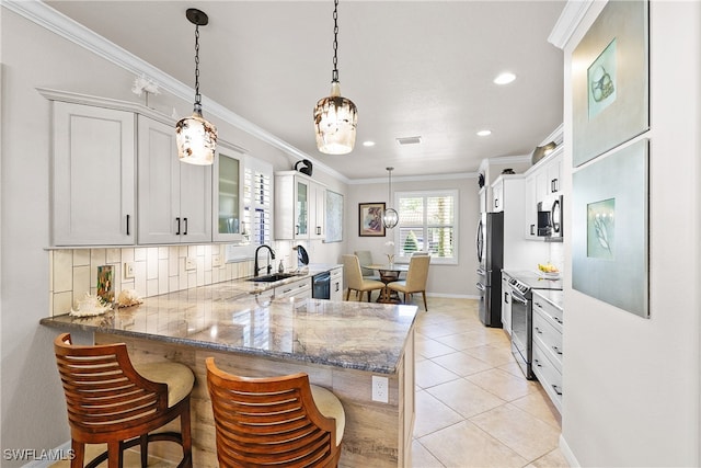 kitchen featuring kitchen peninsula, appliances with stainless steel finishes, white cabinets, and sink