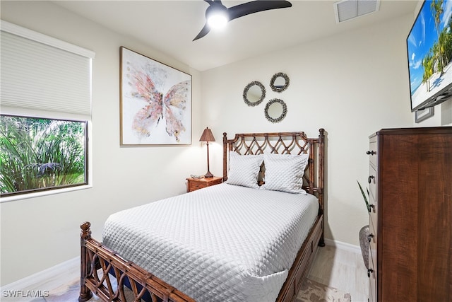 bedroom with ceiling fan and light hardwood / wood-style flooring